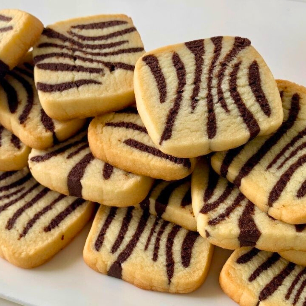 Layering vanilla, chocolate and coffee cookie dough logs to create marbled butter cookies